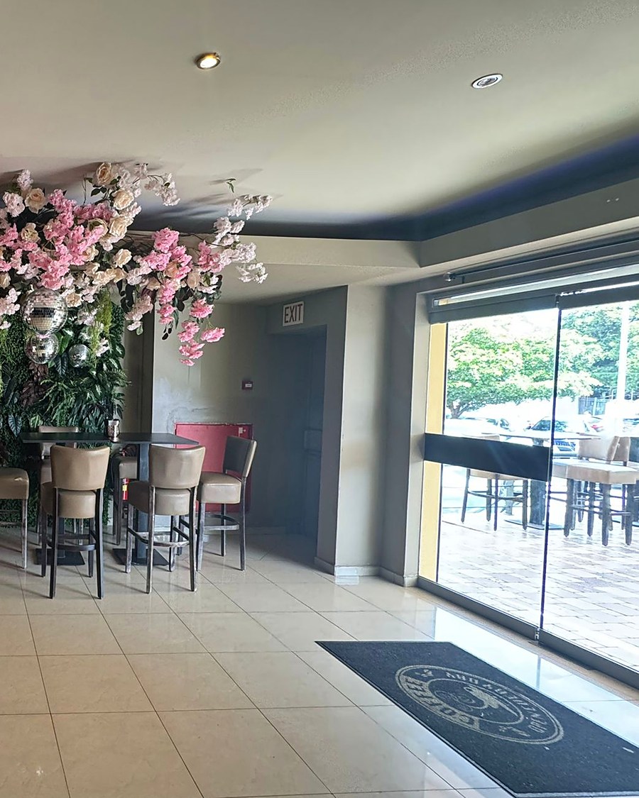 Blossom tree installation and high tables near the entrance